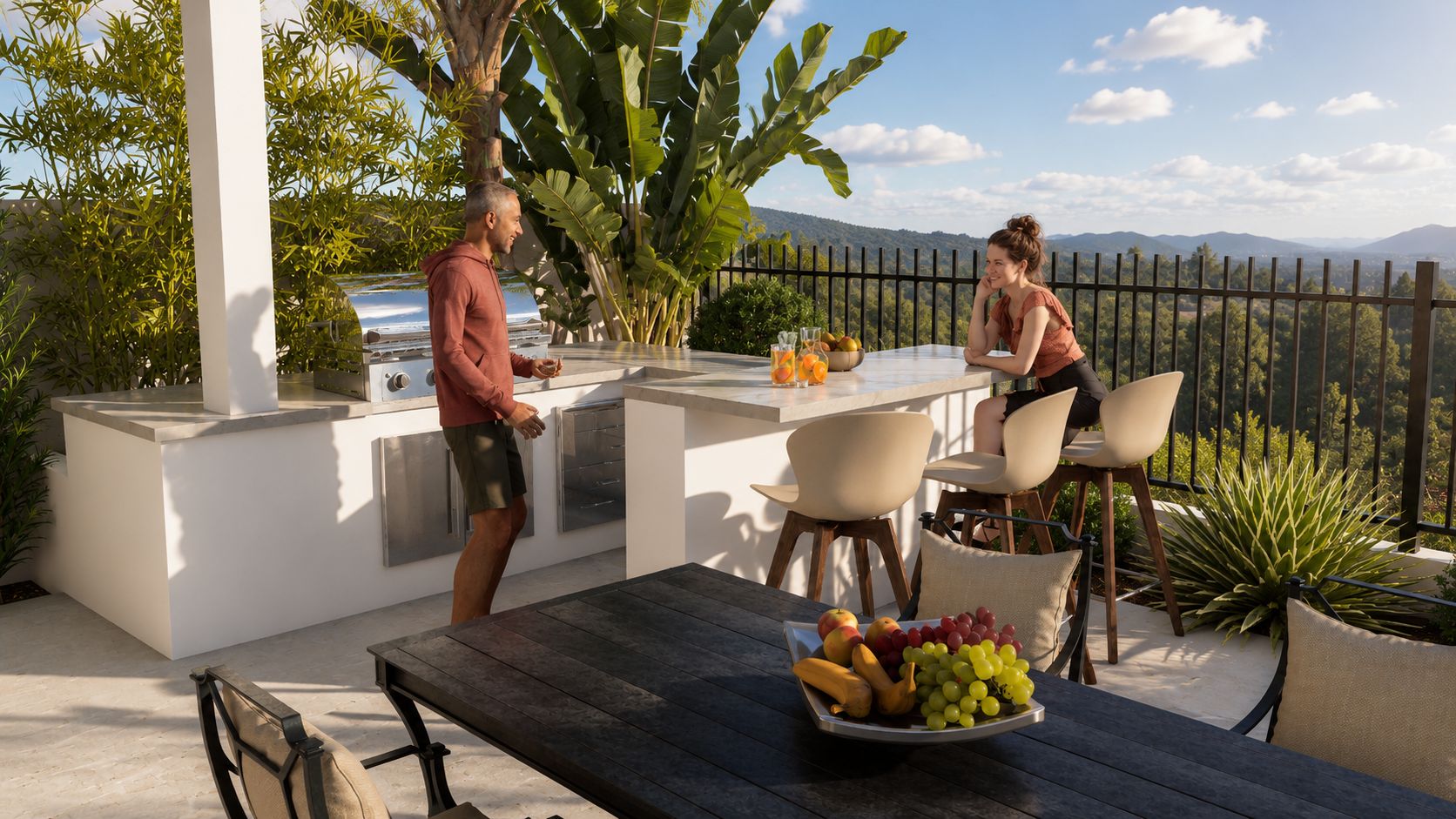Outdoor kitchen and dining area overlooking the Trabuco Canyon landscape with bar seating, covered structure, and Mediterranean planting.